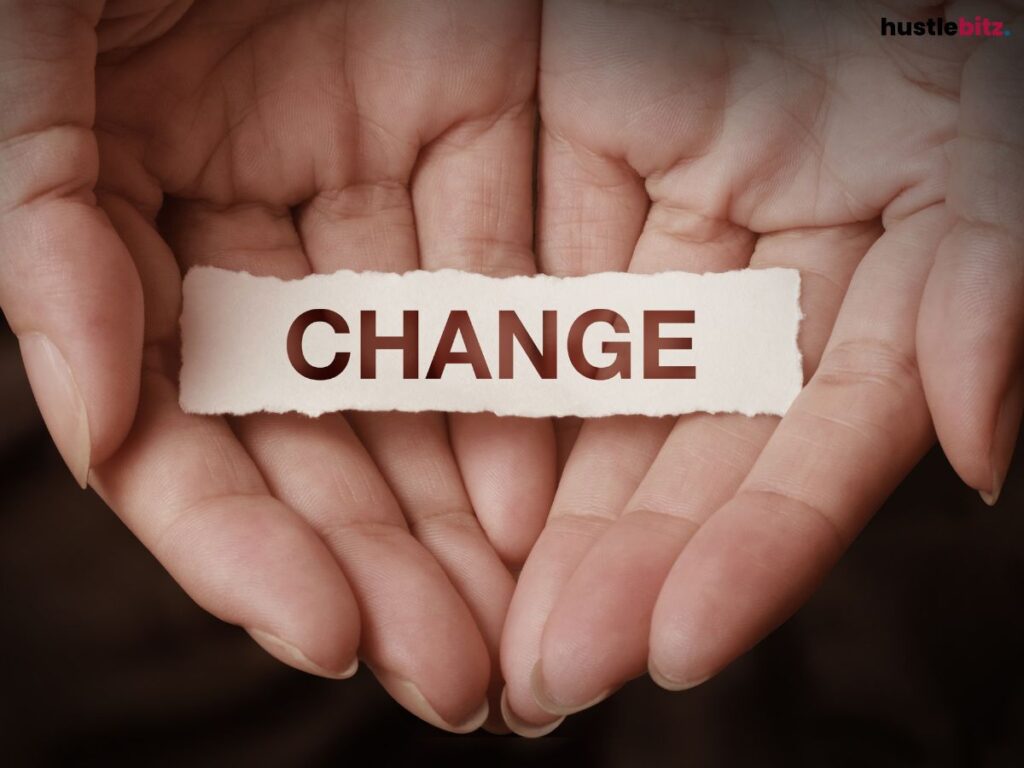 A hand with a piece of paper and the word CHANGE