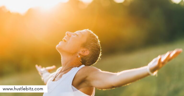 A woman in a field with her arms open