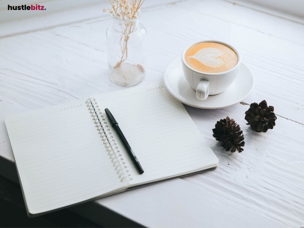 An image of a notebook and a coffee