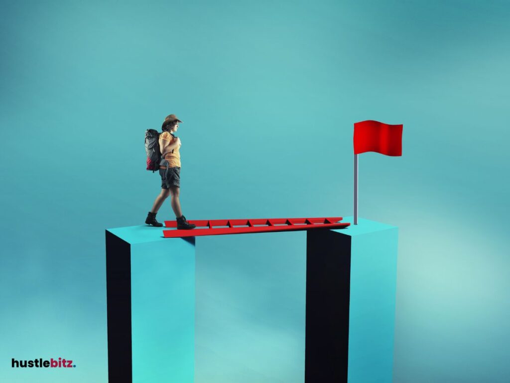 A woman crossing a ladder to get the flag