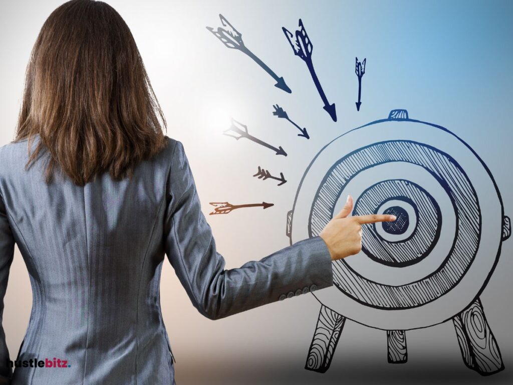 A woman on her back pointing at a target
