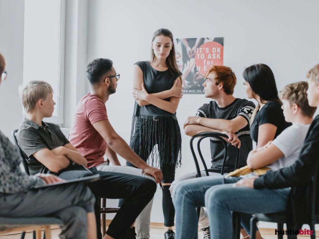 A group of people listening to a woman