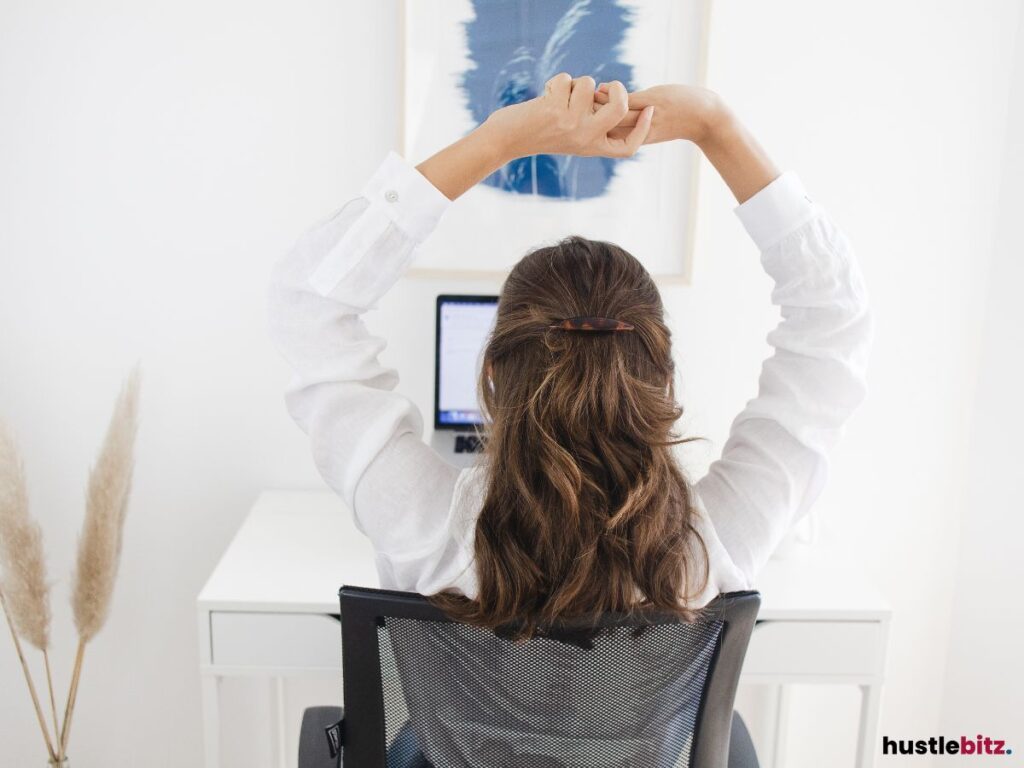 A woman holding her hands up in a form of stretching