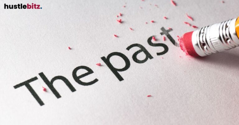 Eraser removing the word "The past" on paper.