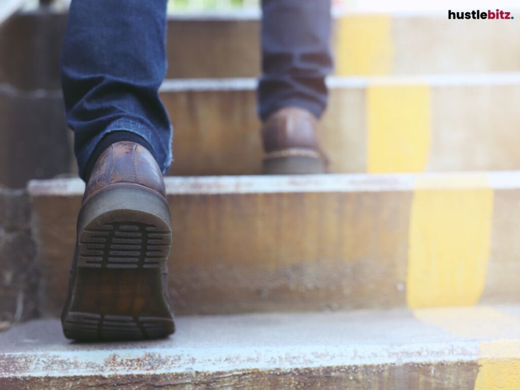 Close-up of someone climbing stairs, focused on their feet.