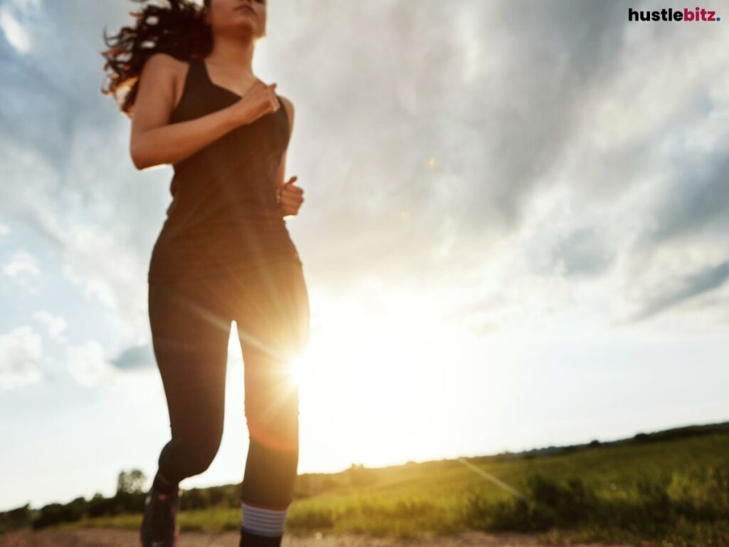 A woman jogging with the ray of light in the background.
