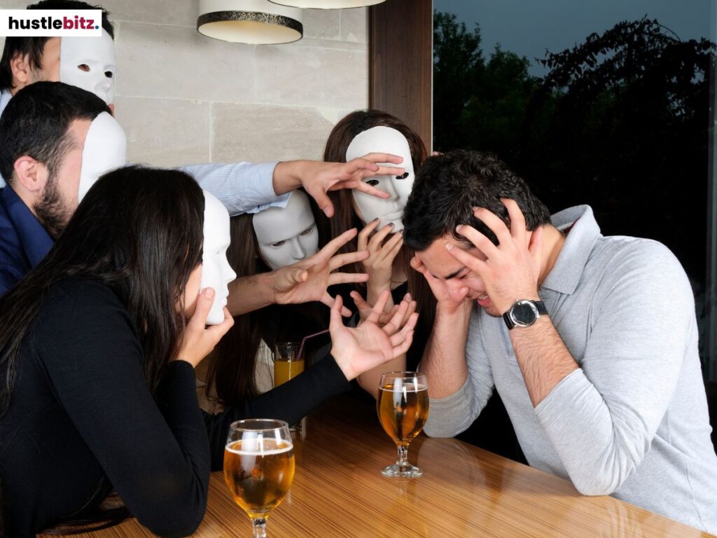 A man holding his head while the people is wearing masks.