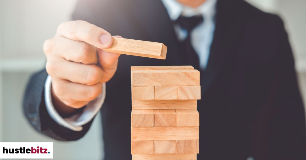 A mans tacking wooden blocks in Jenga Puzzle.