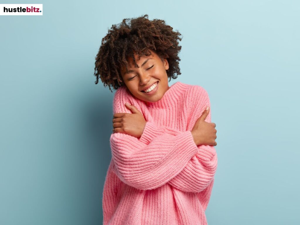A woman hugging herself.
