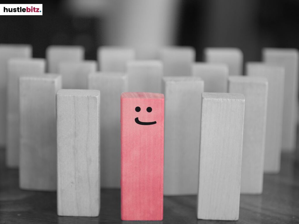 A group of wooden blocks and one of them is pink.