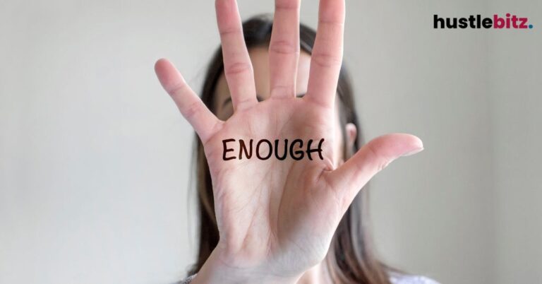 A hand with the word "ENOUGH" written on it, symbolizing setting boundaries.