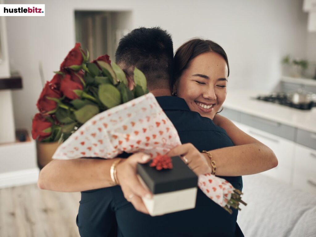 A woman hugging a man for giving her flowers and gifts.