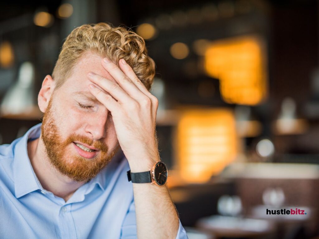 A person holding his head in form of disappointment.