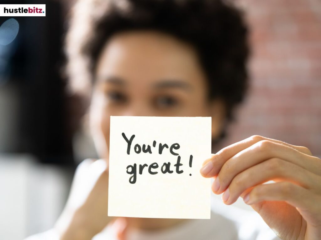 A person holding a note that says: You're Great!
