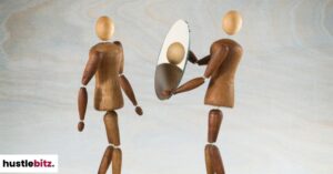 Two ragdolls. One ragdoll holding a mirror.