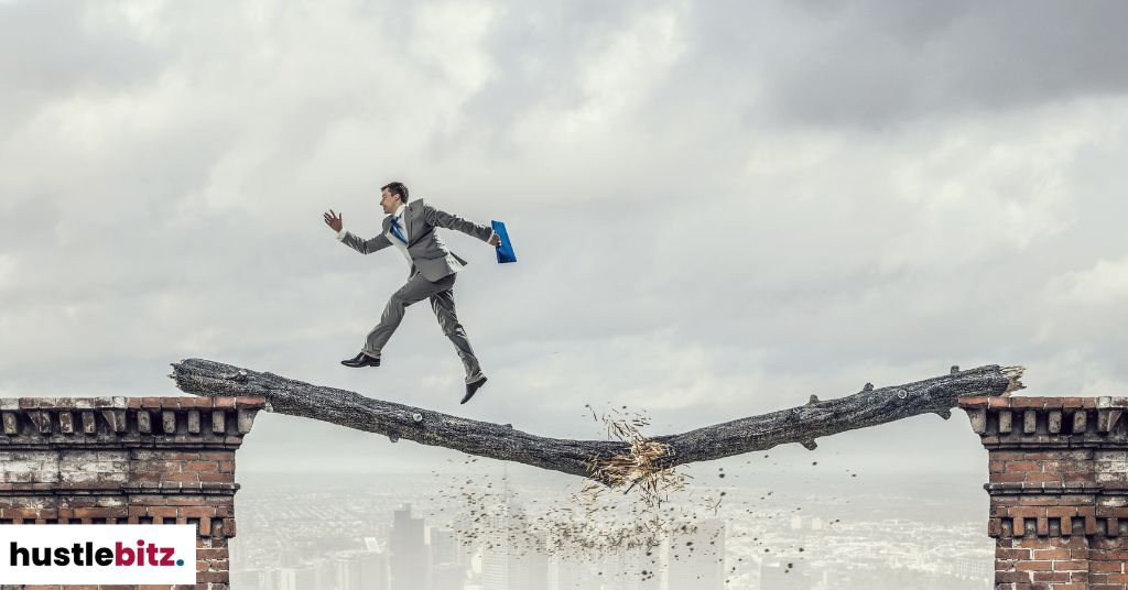 A man crossing a breaking bridge.