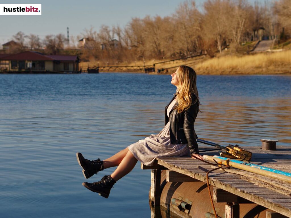 A woman sitting on the boardwalk.