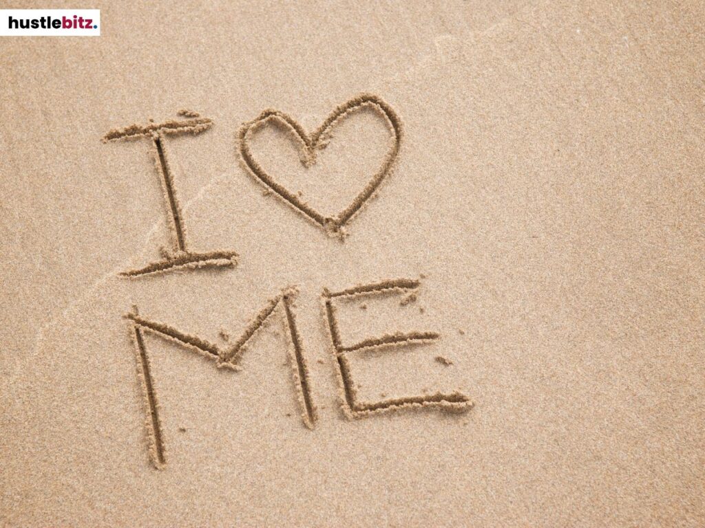 "I Love ME" written in the sand.