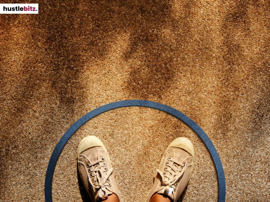 A person's feet inside the circle on the ground.