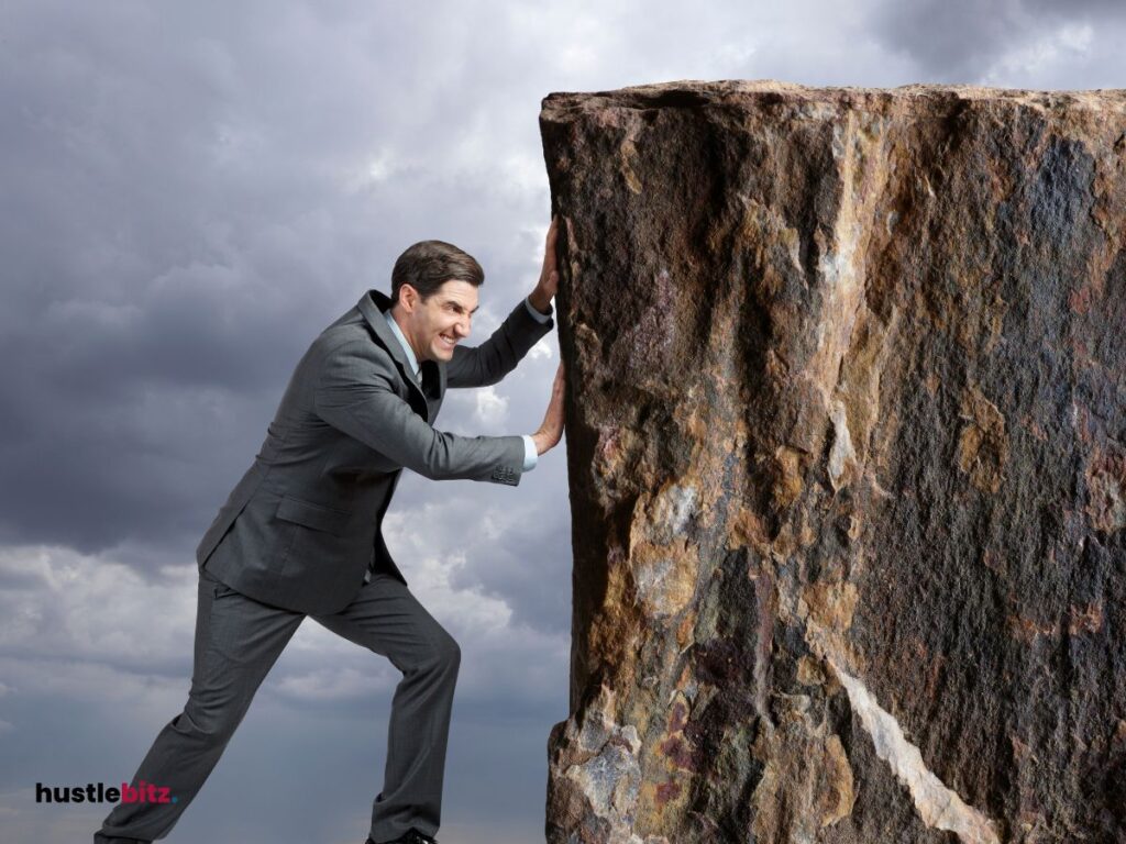 A man pushing a boulder.