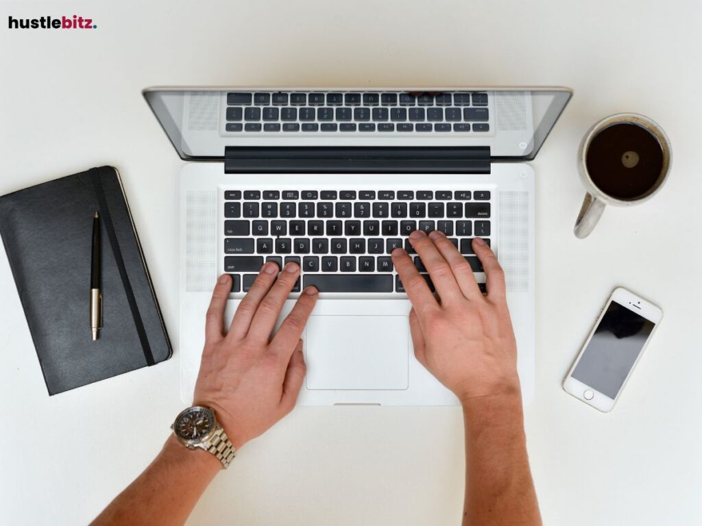 A hands typing on a laptop.