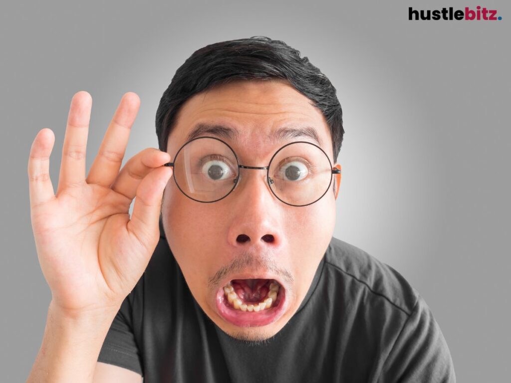 A man with glasses, wide eyes, and an exaggerated surprised expression.